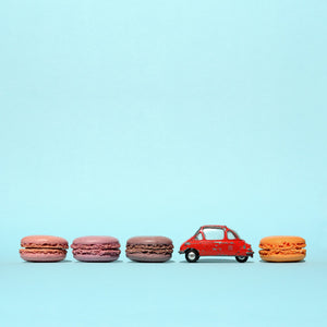 minimalist photography red diecast car